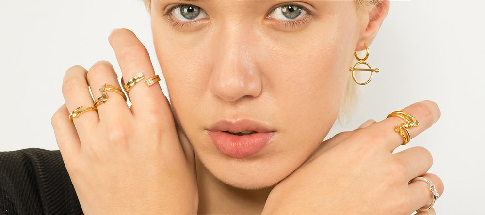 Singula-jewelry-woman-wearing-gold-silver-rings-diamonds-earrings